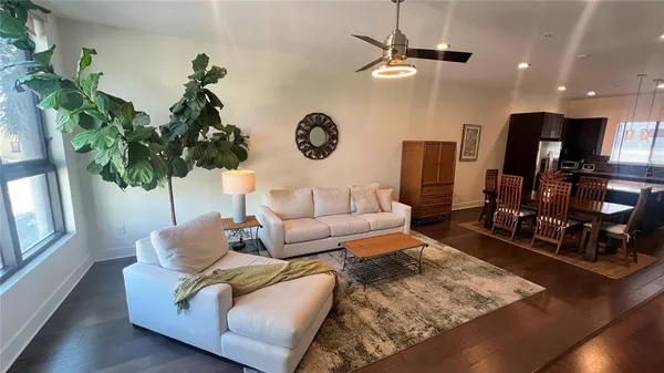 a living room with furniture potted plant and a window