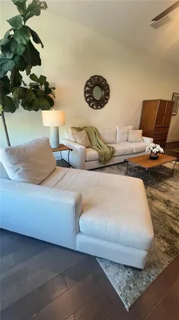 a bedroom with a bed and a potted plant