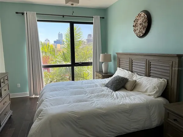 a bedroom with a large bed and a window