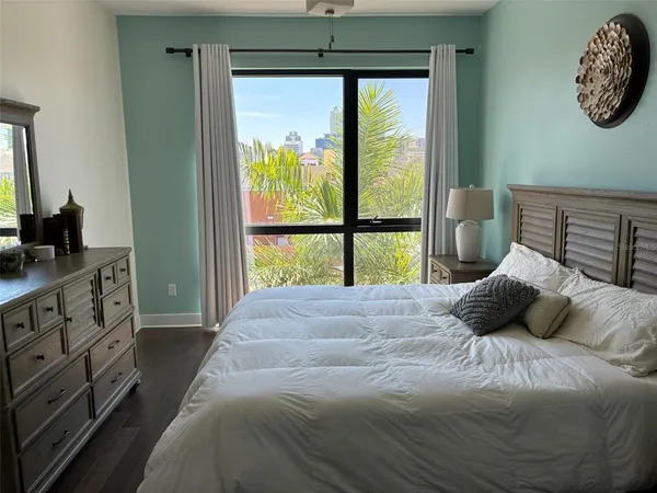 a bedroom with a large bed and a window