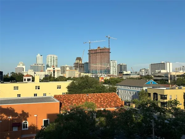 a view of a city with tall buildings and ocean view