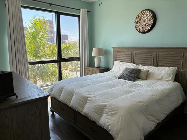 a bedroom with a bed and a window