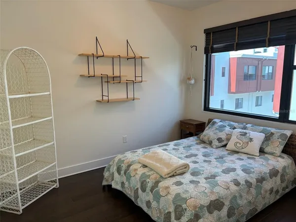 a bedroom with a bed and a window