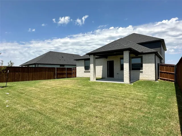 a front view of a house with yard and balcony