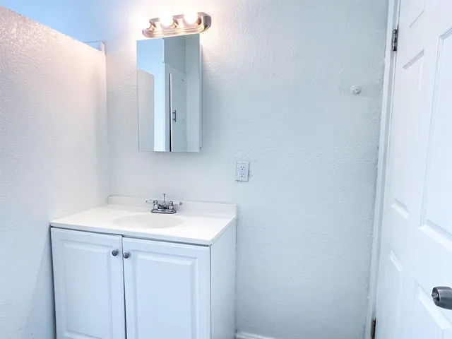 a bathroom with a sink and mirror