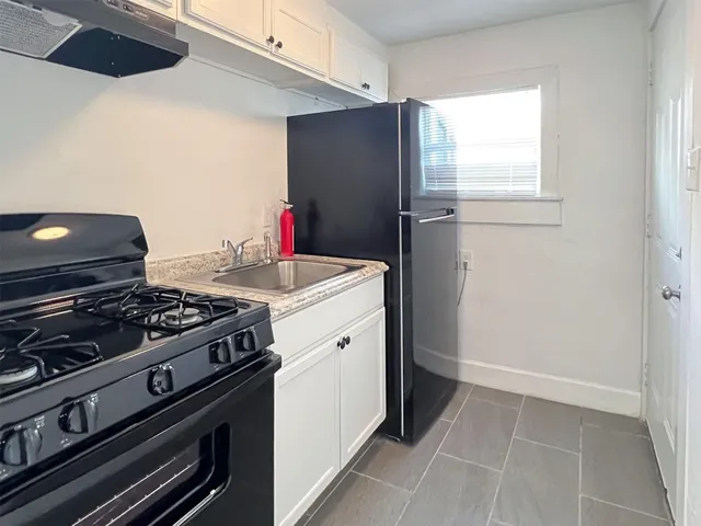 a kitchen with a stove and a refrigerator