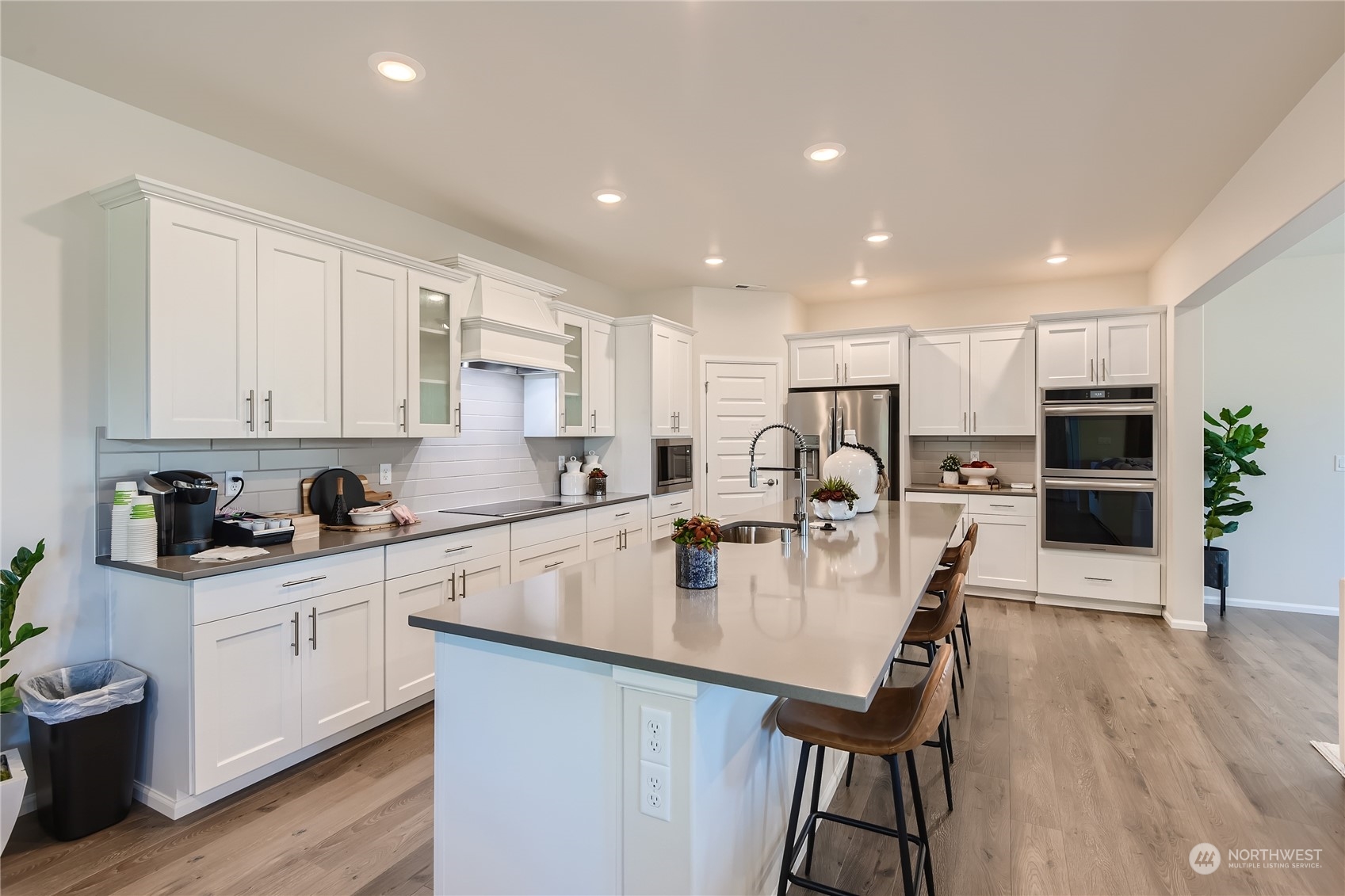 21005 42nd Avenue Southeast, Unit 112 Bothell, WA 98021 - Photo 12 of 24 a kitchen with stainless steel appliances granite countertop a stove top oven a sink dishwasher and a refrigerator with wooden floor