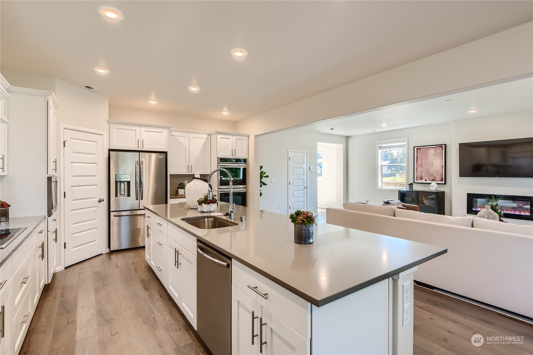 21005 42nd Avenue Southeast, Unit 112 Bothell, WA 98021 - Photo 13 of 24 a kitchen with stainless steel appliances granite countertop a sink a stove and a refrigerator
