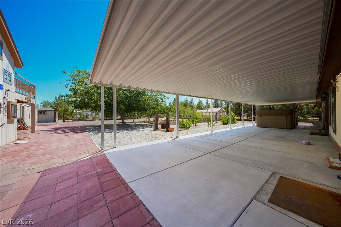 1831 West Horn Road Pahrump, NV 89048 - Photo 35 of 59 A spacious covered patio extends from the home, offering ample outdoor living space.