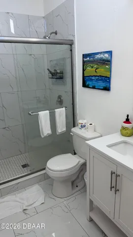 a white toilet sitting next to a bathroom sink