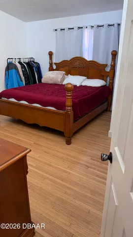 a bedroom with a bed and a night stand