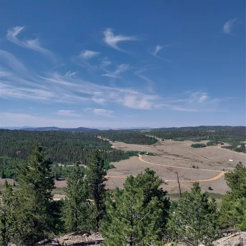a view of a lake with beach and city
