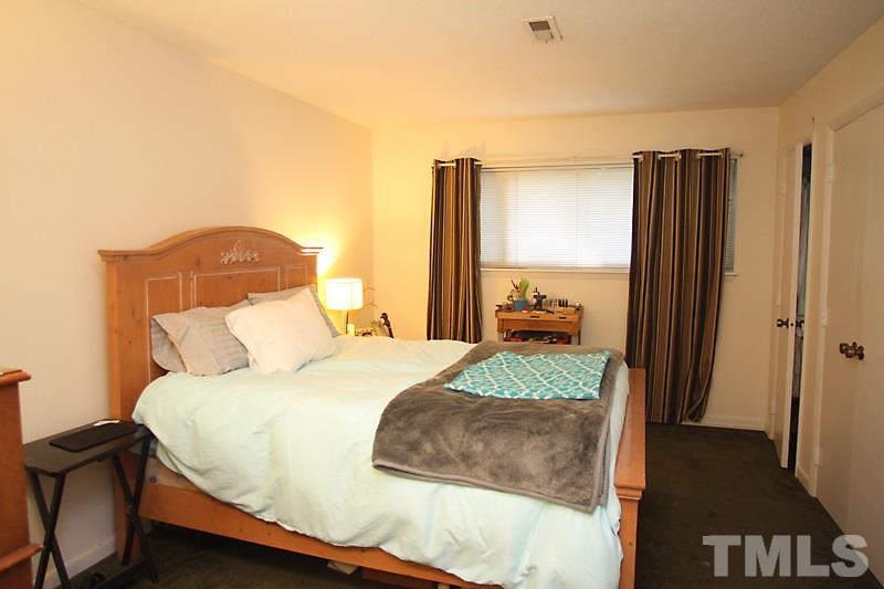 624 Pine Ridge Place, Unit 624 Raleigh, NC 27609 - Photo 6 of 16 Spacious Master Bedroom, Closet, Carpet, Window.