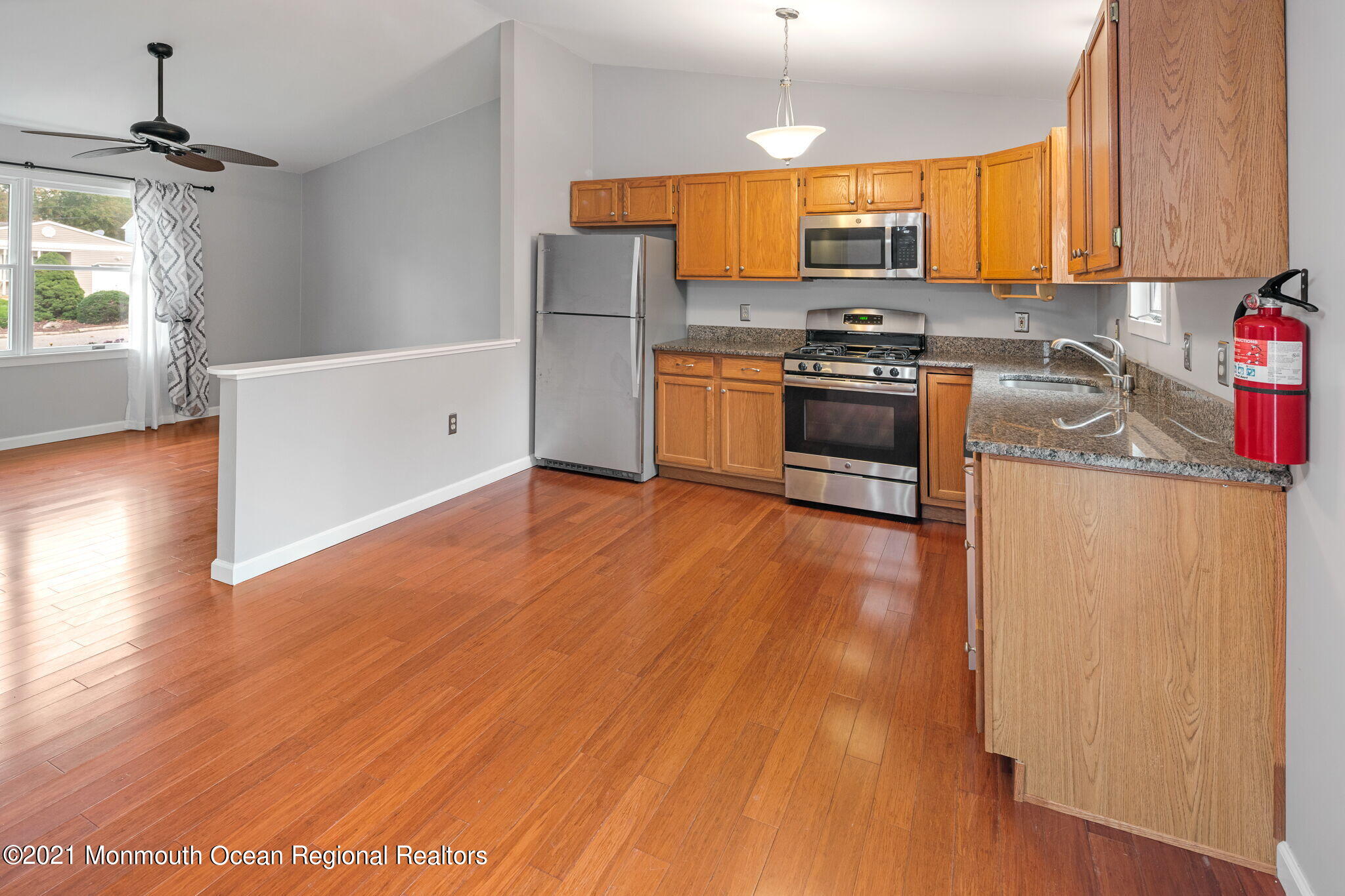 157 Mooring Road Manahawkin, NJ 08050 - Photo 14 of 49 a kitchen with stainless steel appliances a stove a sink and a microwave