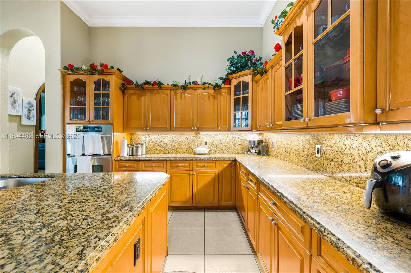 7761 Southwest 122nd Avenue Miami, FL 33183 - Photo 15 of 54 a kitchen with a sink stove and cabinets