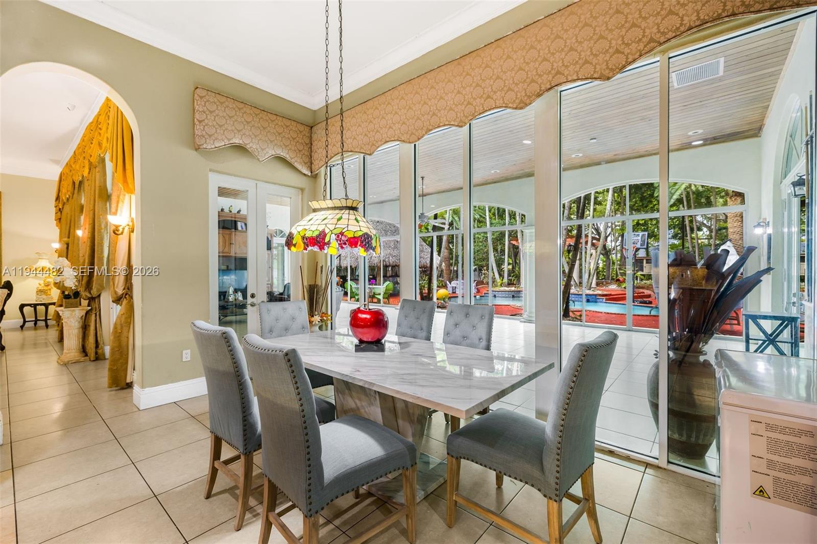 7761 Southwest 122nd Avenue Miami, FL 33183 - Photo 17 of 54 a dining room with furniture and chandelier