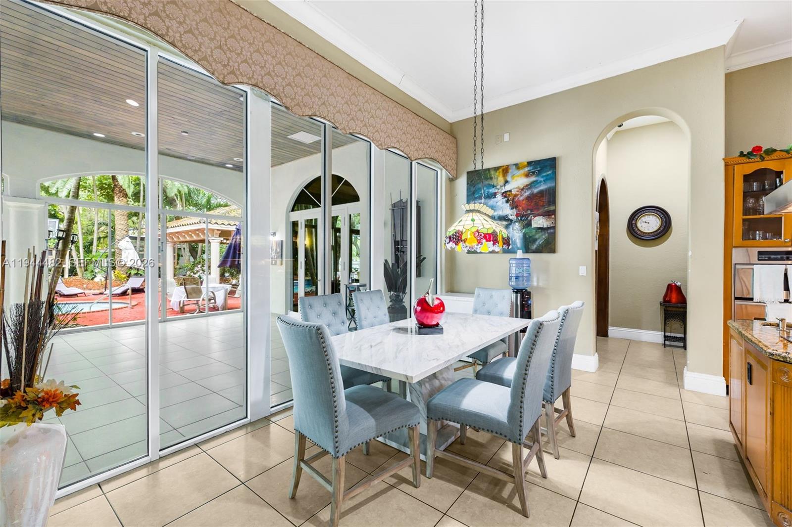 7761 Southwest 122nd Avenue Miami, FL 33183 - Photo 18 of 54 a view of a dining room with furniture one side kitchen view and a chandelier