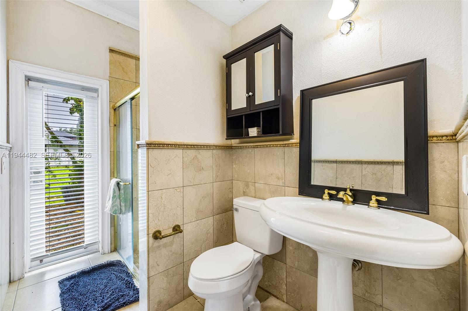 7761 Southwest 122nd Avenue Miami, FL 33183 - Photo 22 of 54 a bathroom with a sink and a mirror