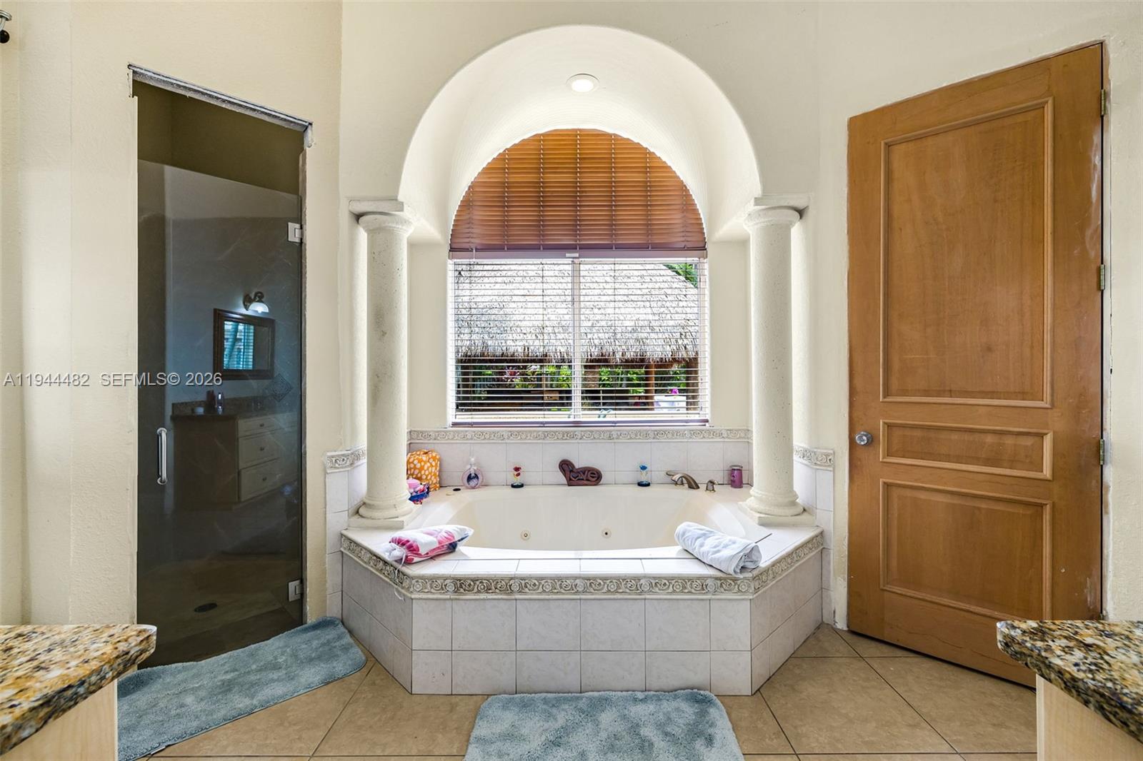 7761 Southwest 122nd Avenue Miami, FL 33183 - Photo 28 of 54 a bathroom with a tub and shower