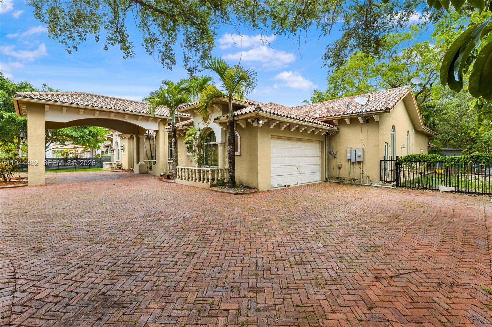 7761 Southwest 122nd Avenue Miami, FL 33183 - Photo 3 of 54 a view of a house with a garage and a yard