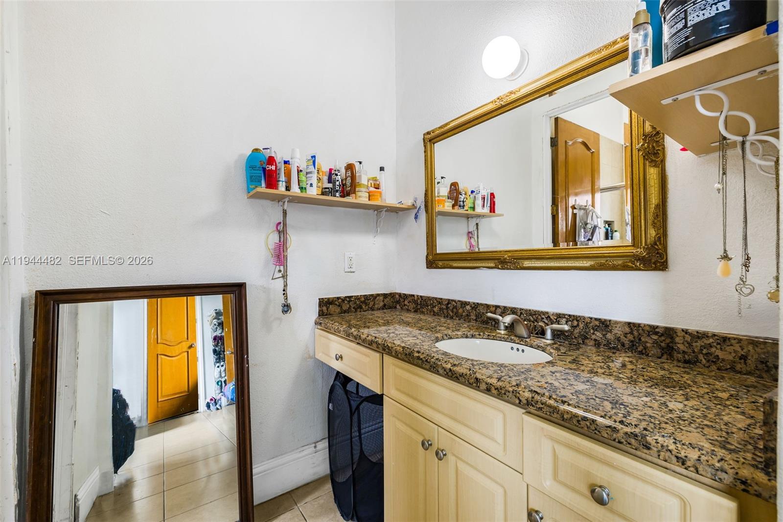 7761 Southwest 122nd Avenue Miami, FL 33183 - Photo 32 of 54 a bathroom with a granite countertop sink and a window