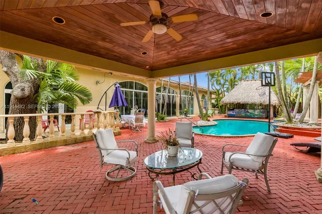 a view of a swimming pool with an outdoor seating