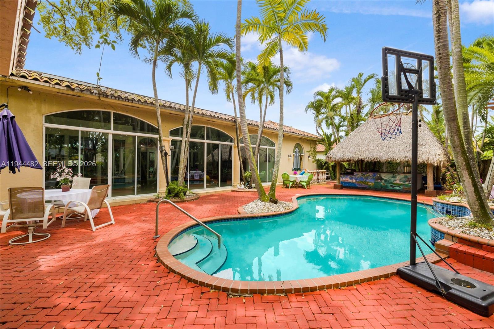 7761 Southwest 122nd Avenue Miami, FL 33183 - Photo 43 of 54 a view of a swimming pool with an outdoor seating