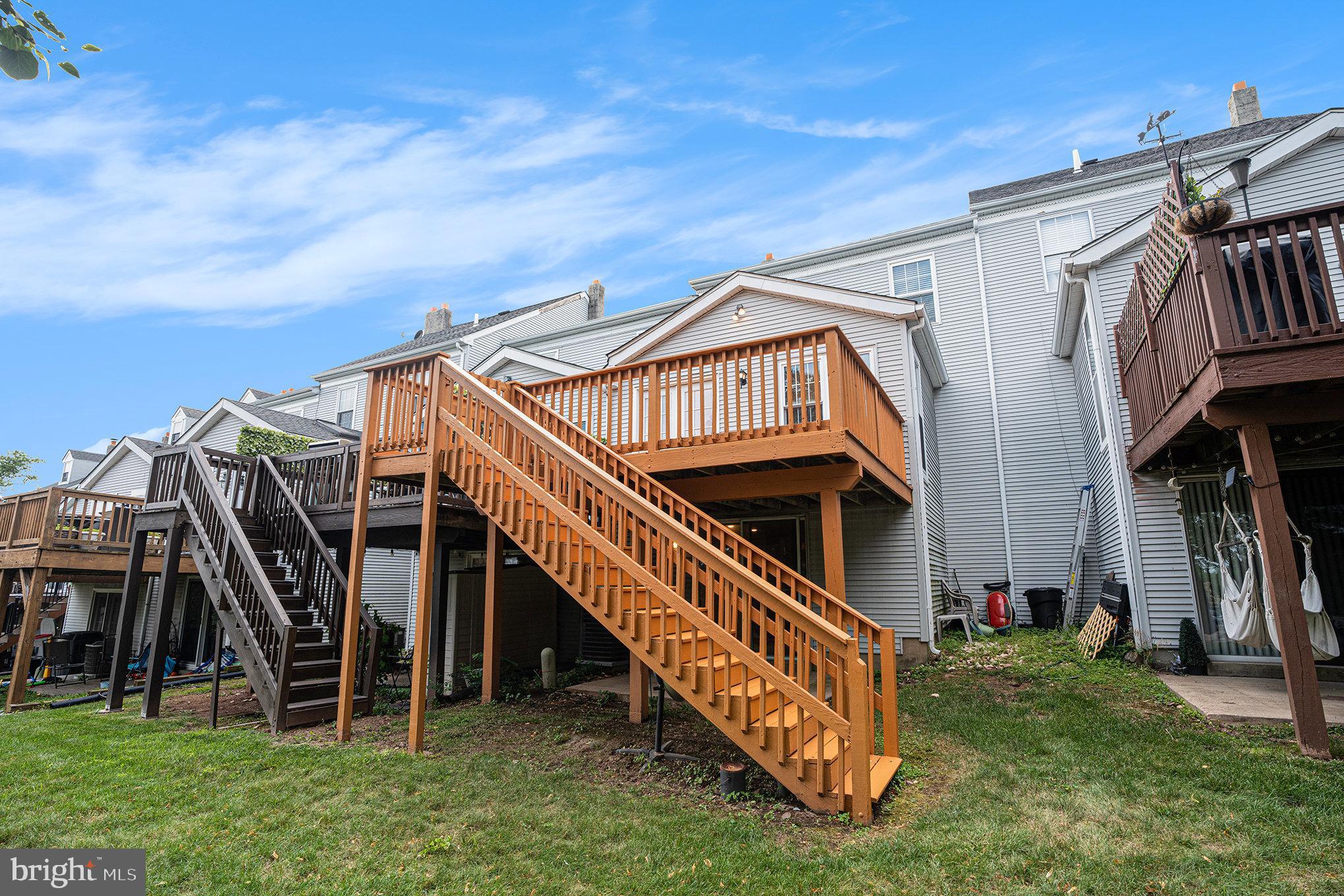 1042 Rafter Road Eagleville, PA 19403 - Photo 23 of 26 a view of a house with a small yard and a wooden deck