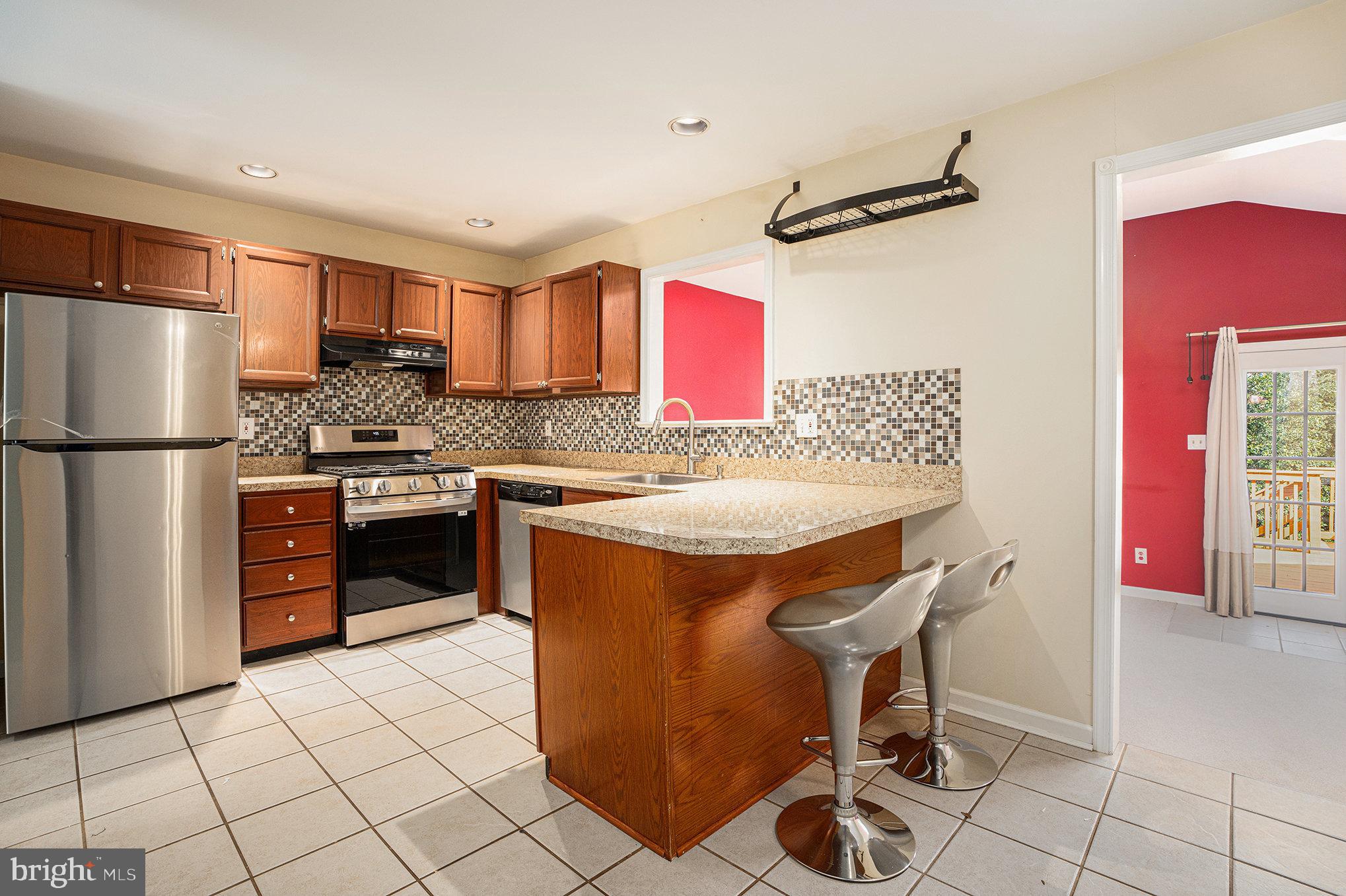 1042 Rafter Road Eagleville, PA 19403 - Photo 6 of 26 a kitchen with stainless steel appliances granite countertop a stove a refrigerator and a refrigerator
