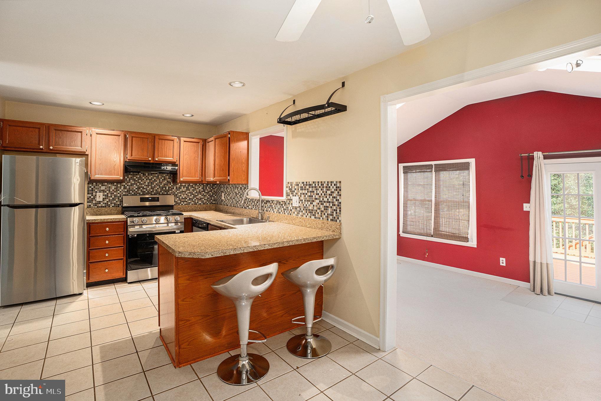 1042 Rafter Road Eagleville, PA 19403 - Photo 9 of 26 a kitchen with a stove a refrigerator and a refrigerator