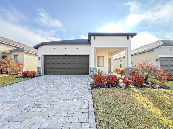 a front view of a house with a yard and garage