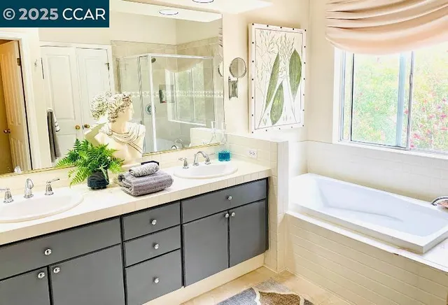 a bathroom with a tub sink and mirror