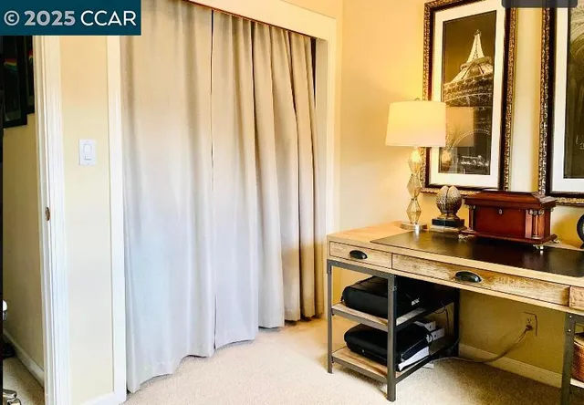 a living room with furniture and a mirror