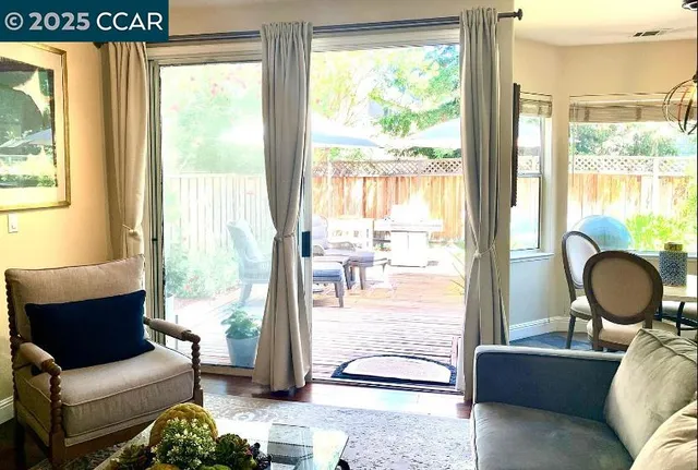 a living room with furniture and a floor to ceiling window