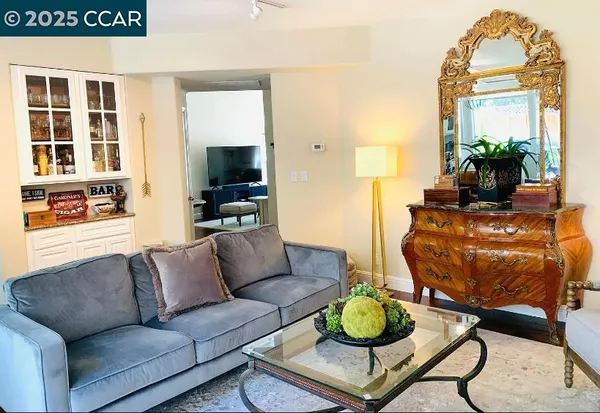 a living room with furniture and a potted plant
