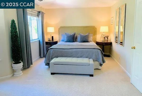 a spacious bedroom with a bed and a window