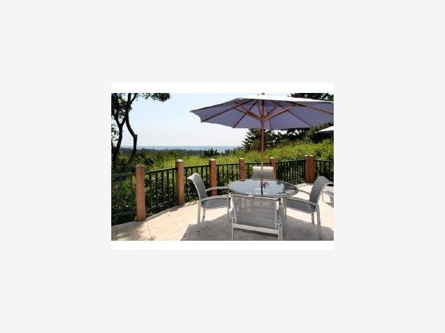 625 Quail Run Road Aptos, CA 95003 - Photo 8 of 8 a view of a patio with a table and chairs under an umbrella