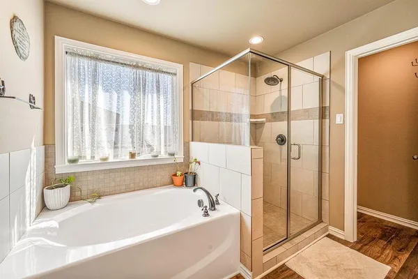 a bathroom with a bathtub and shower