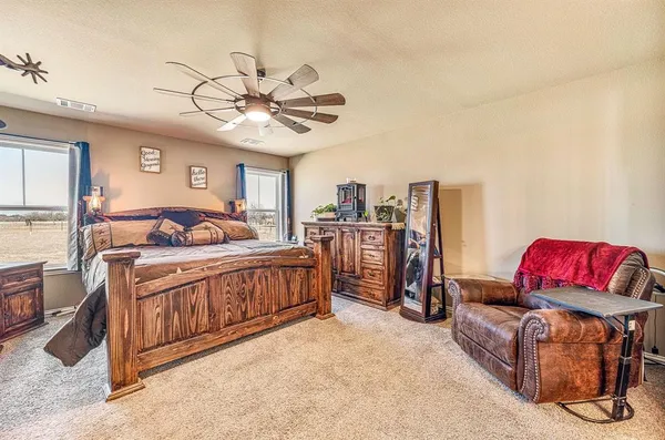 a bedroom with furniture and a chandelier