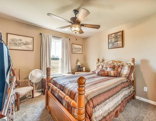 a bedroom with a bed and glass window