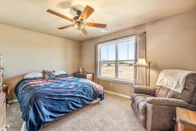 a bedroom with a bed and a couch