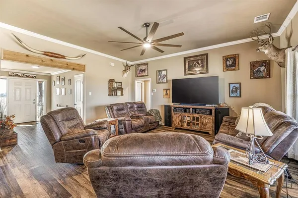 a living room with furniture and a flat screen tv