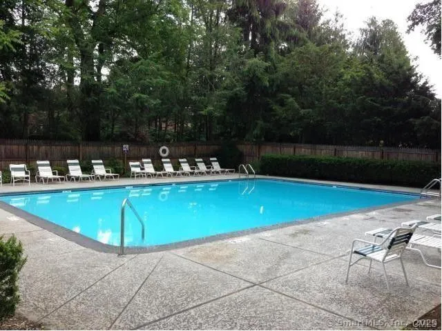 a view of a swimming pool with chairs