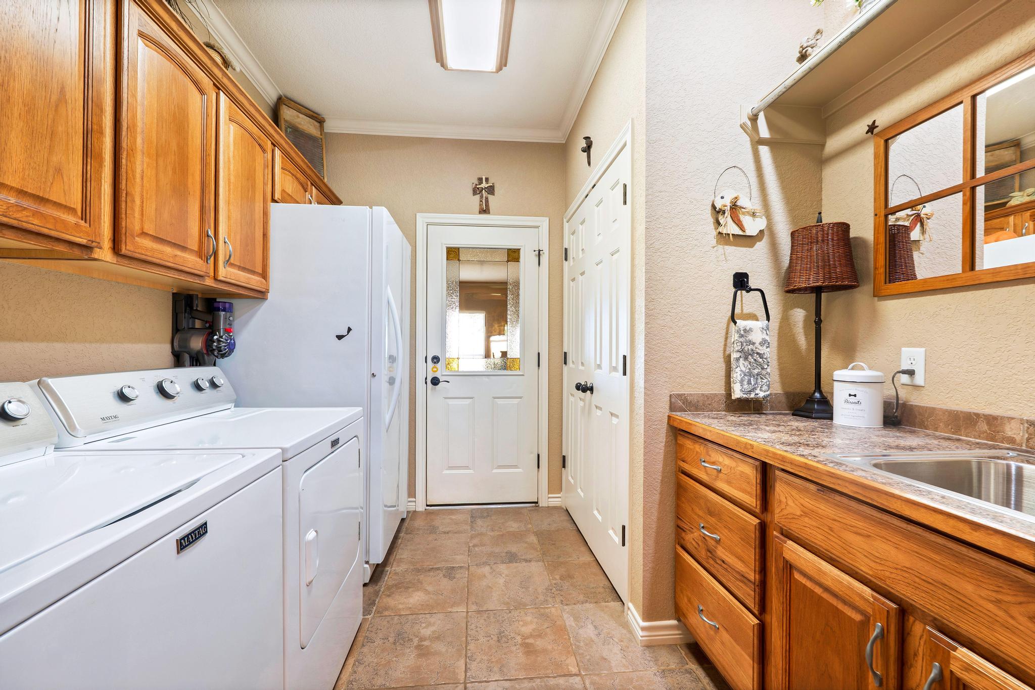 19000 Farm To Market Road 971 Granger, TX 76530 - Photo 26 of 40 The laundry room is ultra-functional with abundant storage and a laundry sink.