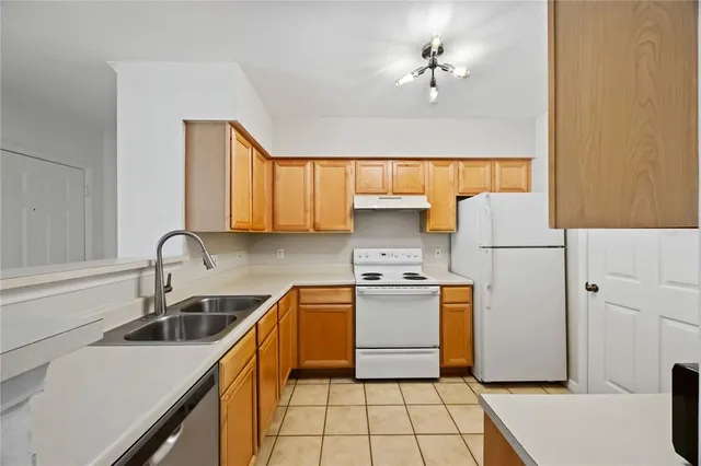 a kitchen with stainless steel appliances a stove refrigerator sink and cabinets