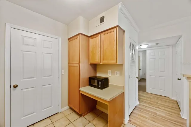 a kitchen with a refrigerator and cabinets