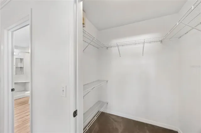 a view of walk in closet with empty racks