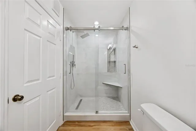 a bathroom with a shower and toilet