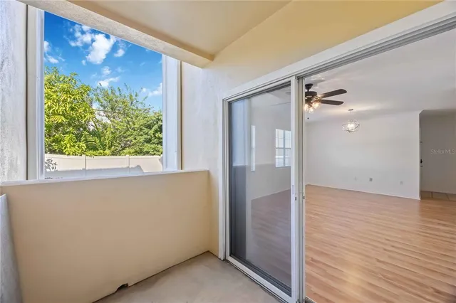 a view of room with window and a ceiling fan