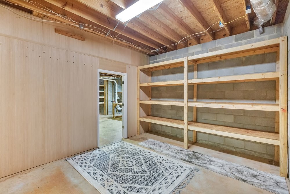 414 Devon Way Anderson, SC 29621 - Photo 31 of 50 Functional unfinished basement space offers generous storage shelves and concrete block walls.